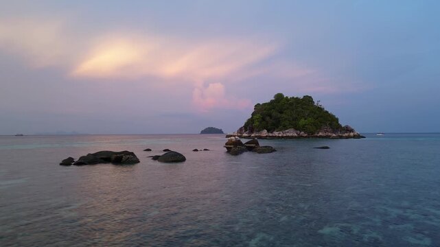 Koh Lipe, Thailand: Aerial drone footage of islets in Koh Lipe, an island in Andaman sea of Thailand. Taken with forward motion on dramatic sunset