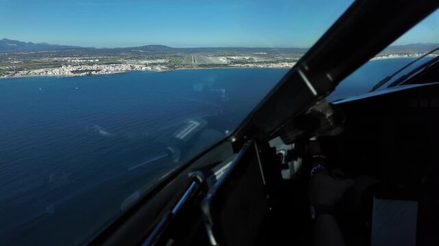 Immersive pilot view in a real time final approach to Palma de Mallorca airport (PMI), flying at low altitude over the Mediterranean Sea, with the runway ahead under a blue sky.