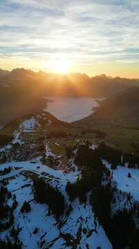 Lake Walen Walensee sunrise Churfirsten mountains valley aerial drone vertical video