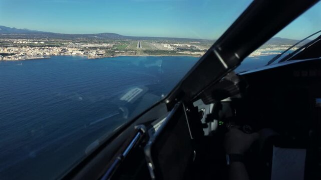 cockpit view in a real time approach to Palma de Mallorca airport runway, flying manually at low altitude over the Mediterranean Sea, with the runway ahead.