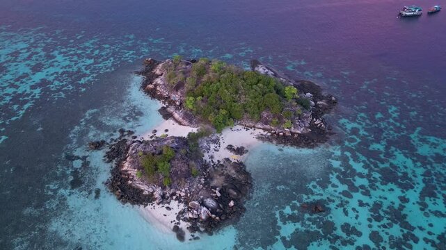 Koh Lipe, Thailand: Aerial drone footage of islets in Koh Lipe, an island in Andaman sea of Thailand. Taken with orbit and downward motion showing the reef in the sea