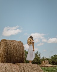 Woman Walking in Countryside Field Under Blue Sky © Magray