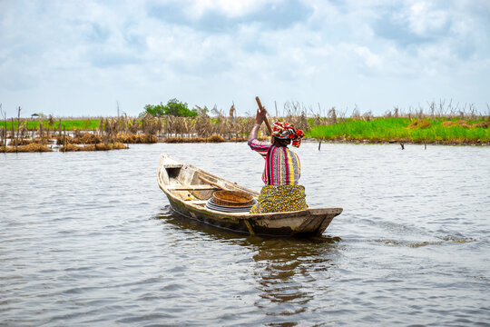 Fishermen in a small boat at lake Nokou&eacute; in Benin, West-Africa