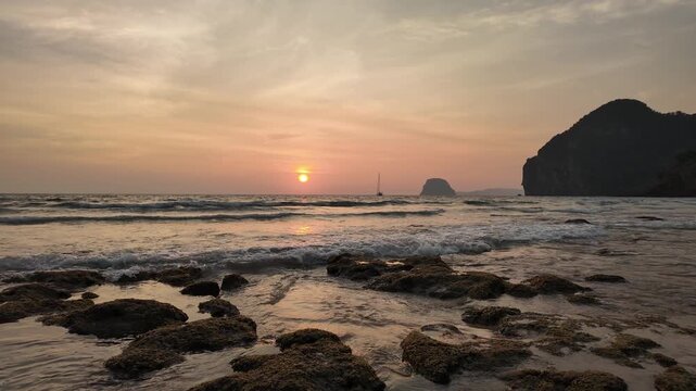 Koh Muk, Thailand: Slow motion footage of wave breaking to Farang or Charlie beach at dramatic sunset situated in Koh Muk, Mook, in the Andaman sea in Trang province in southern Thailand. 