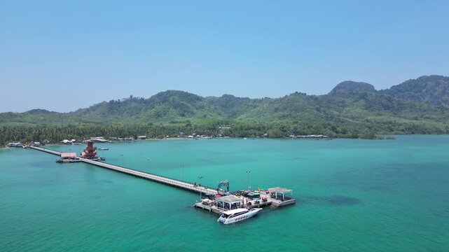 Koh Muk, Thailand: Aerial drone footage of ferry and long tail boats docked in jetty in Koh Mook, an island in Trang province of South Thailand on sunny day