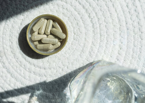 Close-up of iron supplement capsules in a lid for iron deficiency anemia treatment. Health care, wellness, and dietary supplements for daily vitamins and minerals intake.