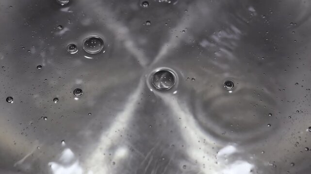 Close up of water boiling texture, water bubbles pattern, air bubbles backdrop in slow motion