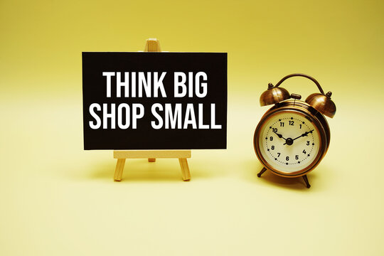 Think Big Shop Small text message and alarm clock on yellow background