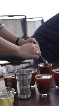 An entry-level barista currently undergoing competency training in coffee preparation