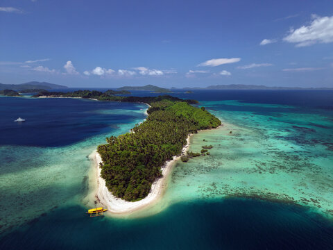 Aerial drone view of Maxima Island lies off the coast of Port Barton beach village in San Vicente town, Palawan, Philippines