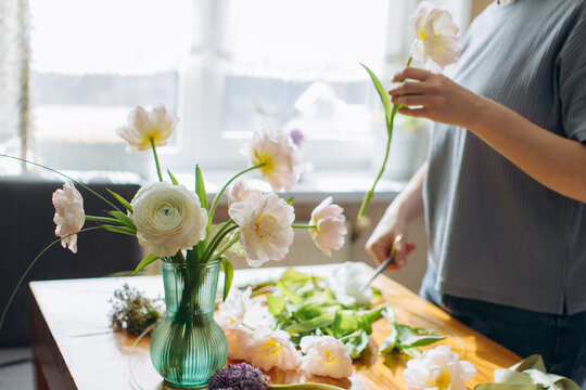 Woman arranging fresh flowers for home decor
