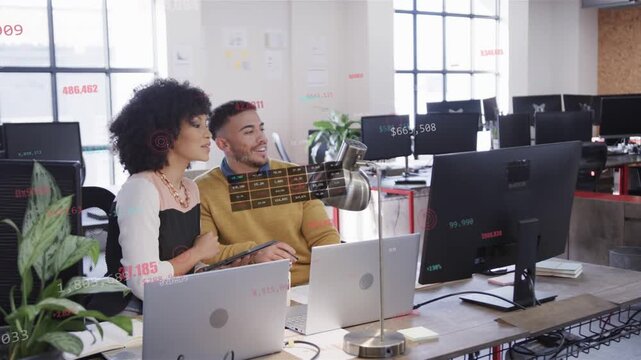 Two coworkers pointing at screen causing animated numbers, tapping tablet and analyzing sales data