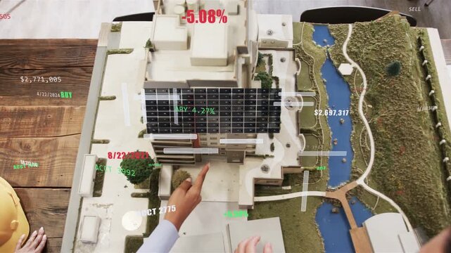 Man placing AR grid on design model, designer assisting while adjusting and analyzing HUD metrics