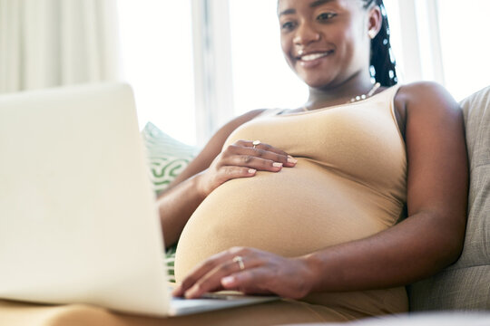 Reading, relax or pregnant woman with laptop on couch, maternity forum or research on fetus development. Home, pc or black person with symptoms tracking for health info, baby registry site or smile