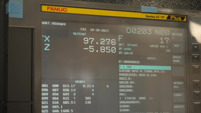 CNC machine control panel display showing machining parameters and absolute coordinates