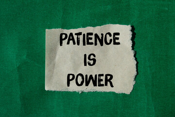 Obraz premium Patience is power message written on ripped torn paper background. Conceptual Patience is power symbol. Copy space.