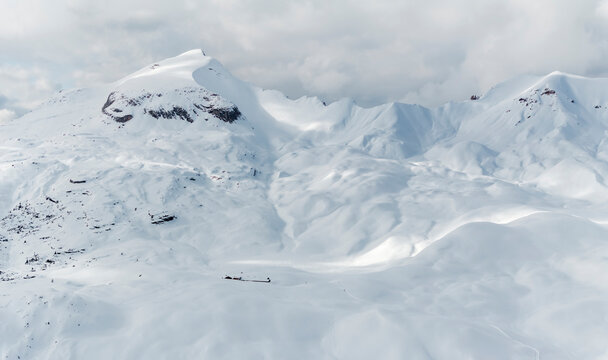 Winter landscape, tourism: Snow covered mountains under cloudy sky, Sennes refuge, Sennes Braies Natural Park, Alto Adige, Veneto, Italy.