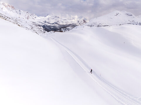 Winter, tourism: Person snowshoeing on a snowy path in a mountain landscape, travel and outdoor lifestyle concept. Sennes refuge,Sennes Braies Natural Park,Alto Adige,Veneto,Italy.