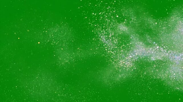 A vibrant iridescent glitter particle burst explodes and disperses across the frame with brilliant magical shimmer