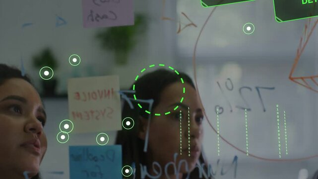 Affixing pink note, central woman leading planning, writing on glass while HUD labels appearing