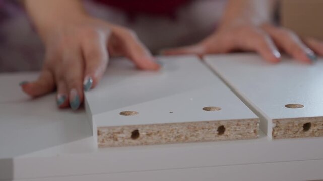 Precise Cabinet Assembling. Aligning Shelves With Detailed Accuracy. Specialist Hand Positioning For Perfect Furniture Fit. Demonstration Of Meticulous Shelf Edge Alignment Procedures