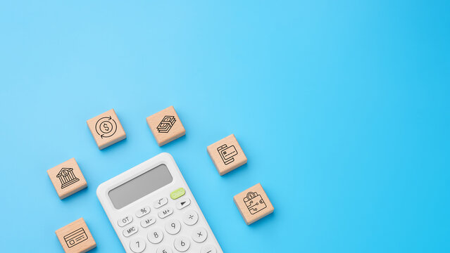 Calculator with wooden blocks and payment icons for money flow