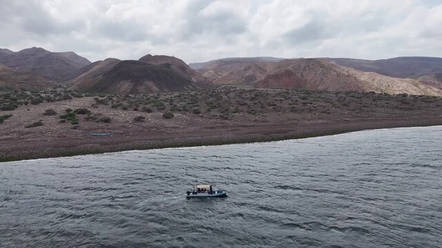 Drone shot of Djibouti Red Sea coastline with scenic ocean view, rotating drone shot of boat in the water.