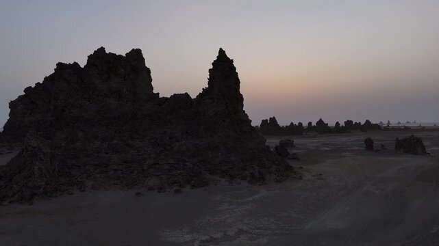 Drone footage of jagged rock formations in arid landscape near the Red Sea coastline, wide aerial footage.