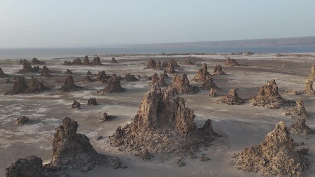 Drone view of rugged desert landscape with scattered rock formations near the Red Sea, wide aerial footage.