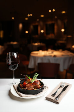 Whole Roasted Quail with Golden Potatoes and Grilled Tomato.