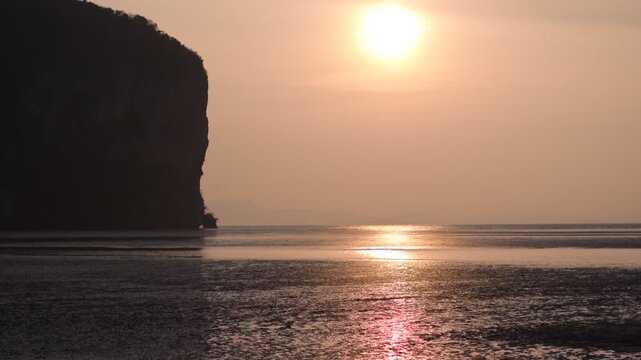 Hat Ratcha Mongkhon beach in Sikao District, Trang, Thailand. Tropical coastline with scenic rock formations, Golden Sun Sunset Beach