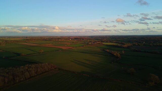 Golden hour sunset light glows over yorkshire farming land and fields in North Yorkshire outside Harrogate Spa Town