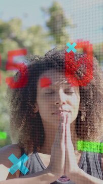 Vertical video: Woman praying as camera pulling back, 37