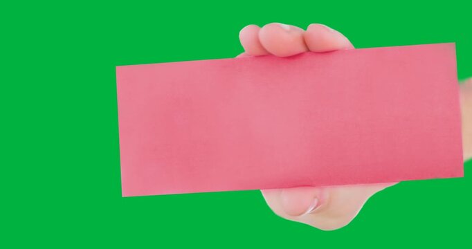 Hand holding a blank pink placard ith with copy space against black background