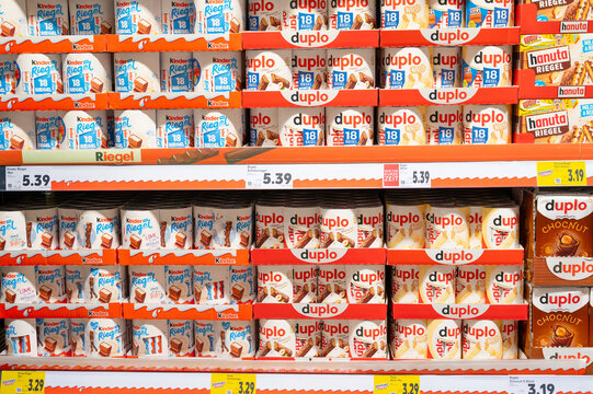 Kinderriegel and Duplo chocolate assortment at store shelf in supermarket, price increase of sweets, inflation and sugar tax, Trier, Germany