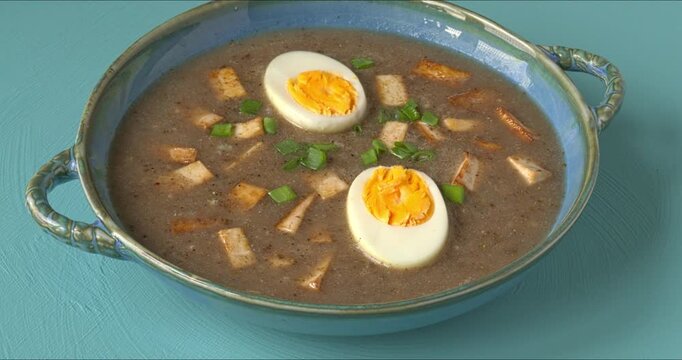 Vegetarian version of sour rye soup, a fermented, tangy soup made from rye flour, sourdough starter, garlic, root vegetables, and tofu, served with hard-boiled eggs. Zoom in while rotating.