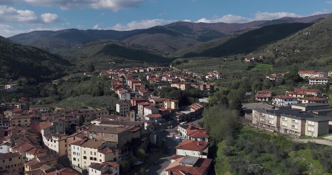 Aerial view of the historic village of Loro Ciuffenna with stone houses and green hills in Loro Ciuffenna, Tuscany, Italy.