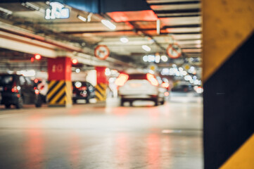 Fototapeta premium Underground parking garage in urban area showing vehicles moving between parking spaces in a busy transport facility during daytime hours