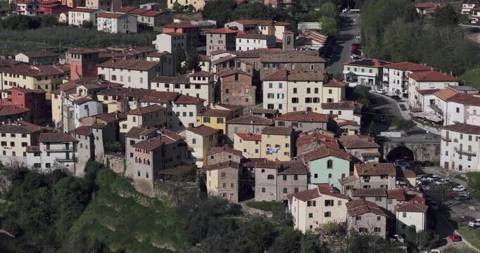 Aerial view of the historic stone buildings and terracotta rooftops of the hillside village of Loro Ciuffenna, Tuscany, Italy.