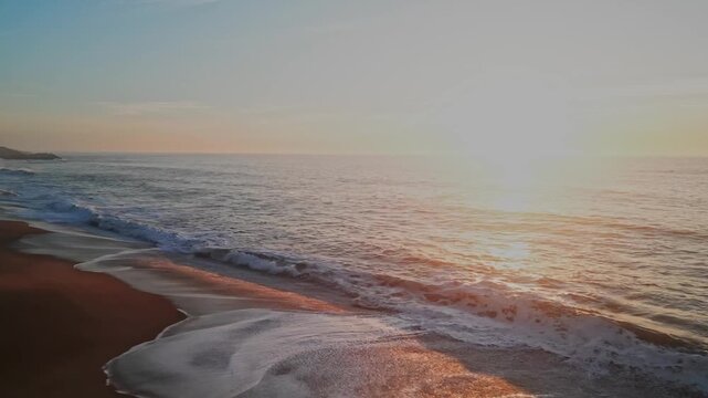 Golden sunset over Salgado Beach in Nazar&eacute;, Portugal, serene and tranquil