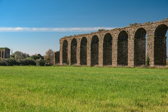 Aspendos Ancient Roman aqueduct ruins in green spring meadow
