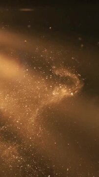 Golden particles swirling in dark atmosphere create magical effect in this mesmerizing motion background footage that through space for high quality artistic projects and digital visual content