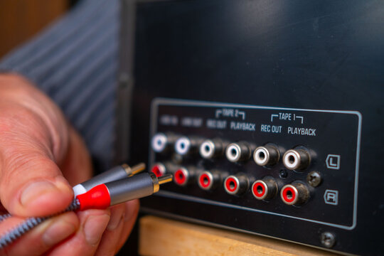 Black phono preamplifier with RCA connectors, ground terminal, power input jack, close-up view, High-fidelity audio equipment, Quality Essential gear for audiophiles, analog device for turntable