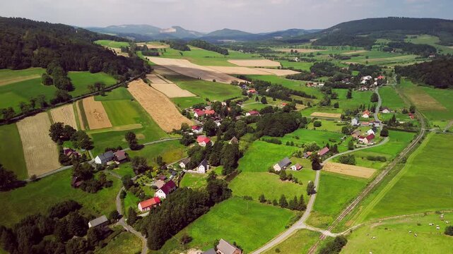 Aerial Drone View of Rural Village in Lower Silesia in the morning, Rolling Hills and Late Summer Landscape