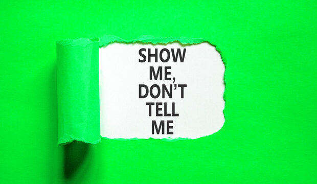 Tell or show symbol. Concept words Show me, do not tell me on beautiful white paper. Beautiful green paper background. Business tell or show concept. Copy space.