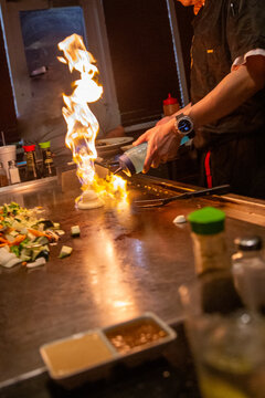 Hibachi chef faming up the vegetables