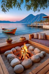 Fototapeta premium Bonfire on a lakeside beach at Lake Atitlán, Guatemala, with wooden boat, dock and volcano views