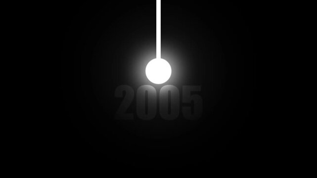 A glowing white sphere suspended by a thin white rod against a stark black background with the year 2005 subtly displayed behind it