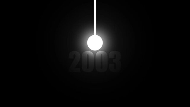 A luminous white sphere, suspended by a white rod, glows brightly against a black background with the year 2003 subtly visible in faded gray text below