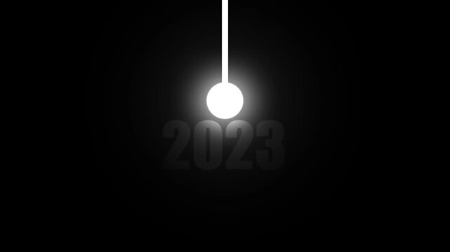 A radiant white pendulum ball swings and casts light on the year 2023 in a dark, minimalist abstract composition symbolizing time, change, and the onward march of progress with a stark